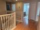 Hallway area with access to a bathroom, bedrooms, and a staircase at 5966 Willows Bridge Loop, Ellenton, FL 34222
