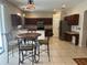 Bright eat-in kitchen features stainless appliances, tile floors and dark cabinets at 5966 Willows Bridge Loop, Ellenton, FL 34222