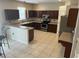 Spacious kitchen featuring dark wood cabinets and stainless steel appliances at 5966 Willows Bridge Loop, Ellenton, FL 34222