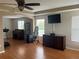 Large living room with tray ceiling, dark wood furniture, and windows allowing plenty of natural light at 5966 Willows Bridge Loop, Ellenton, FL 34222