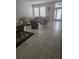Inviting living room with tile flooring, neutral walls, and lots of natural light at 5966 Willows Bridge Loop, Ellenton, FL 34222