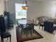 Neutral living and dining area with tile floors and lots of natural light at 5966 Willows Bridge Loop, Ellenton, FL 34222