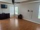 Large main bedroom with wood-look floors, ceiling fan, and windows providing natural light at 5966 Willows Bridge Loop, Ellenton, FL 34222