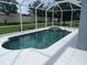 A view of an enclosed pool that features a hot tub and white deck surrounding it at 5966 Willows Bridge Loop, Ellenton, FL 34222