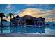 Clubhouse with a pool and blue lounge chairs, reflecting the sunset in its waters at 5966 Willows Bridge Loop, Ellenton, FL 34222