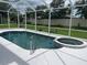 A view of the enclosed pool featuring a hot tub and a white deck surrounding it at 5966 Willows Bridge Loop, Ellenton, FL 34222