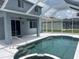 Backyard pool with jacuzzi tub, white deck, and screened-in porch with fan at 5966 Willows Bridge Loop, Ellenton, FL 34222
