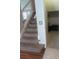 Carpeted stairs with a white railing, leading to the upper level of the home at 5966 Willows Bridge Loop, Ellenton, FL 34222
