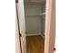 Walk-in closet providing ample storage space with white shelving and hardwood flooring at 5966 Willows Bridge Loop, Ellenton, FL 34222