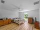 Spacious bedroom featuring light hardwood floors, a window, and dresser set at 6199 Stamp St, Port Charlotte, FL 33981