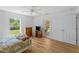 Bedroom with hardwood floors, natural light, dresser, and a glass panel door to the outside at 6199 Stamp St, Port Charlotte, FL 33981