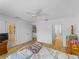 Bright bedroom features hardwood floors, ceiling fan, and ensuite bathroom for added convenience at 6199 Stamp St, Port Charlotte, FL 33981