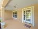 Covered entryway with double doors and a small porch area, perfect for welcoming guests at 6199 Stamp St, Port Charlotte, FL 33981