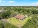 Single story home featuring lush lawns, mature trees, and a paved driveway in a serene community setting at 6199 Stamp St, Port Charlotte, FL 33981