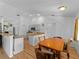Eat-in kitchen features wood breakfast bar, neutral paint, and hardwood floors at 6199 Stamp St, Port Charlotte, FL 33981
