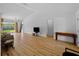Bright living room with wood floors, and sliding glass doors to backyard at 6199 Stamp St, Port Charlotte, FL 33981