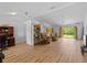 Spacious open-concept living area with wood floors and sliding glass doors to the backyard at 6199 Stamp St, Port Charlotte, FL 33981