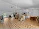 Open concept living and dining area with hardwood floors and neutral paint at 6199 Stamp St, Port Charlotte, FL 33981