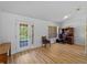 Bright home office featuring wood floors, natural light, and a functional built-in desk and shelving unit at 6199 Stamp St, Port Charlotte, FL 33981