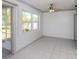 Spacious and bright enclosed back porch with tiled floor and windows at 6231 Jordan St, North Port, FL 34287