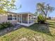 Backyard view showcasing a screened lanai and lush greenery, creating a private outdoor oasis at 6231 Jordan St, North Port, FL 34287