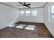 A bright bedroom with vinyl floor, a ceiling fan, and large windows, bathed in natural light at 6231 Jordan St, North Port, FL 34287