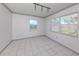 Bright room features white tile floors, neutral walls and a large window for lots of natural light at 6231 Jordan St, North Port, FL 34287