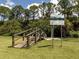 A wooden bridge over a creek or waterway with informative signs about water conservation at 6231 Jordan St, North Port, FL 34287