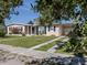 Charming single-story home with a well-maintained lawn, flowering bushes, and a welcoming entrance at 6231 Jordan St, North Port, FL 34287