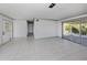 Bright living room features tile flooring, sliding glass doors, and neutral wall color to create an airy space at 6231 Jordan St, North Port, FL 34287