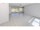 Open-concept living space with tile flooring leading to a screened porch and multiple windows at 6231 Jordan St, North Port, FL 34287