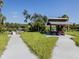 Park shelter by the water's edge with a concrete pathway and a wooden picnic table at 6231 Jordan St, North Port, FL 34287