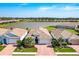 Stunning aerial view of the beautiful community, highlighting the lake and manicured landscaping at 629 Ibiza Loop, Venice, FL 34292