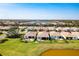 Aerial view of a home with a large backyard, patio, pond view, and community amenities at 629 Ibiza Loop, Venice, FL 34292