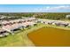 Aerial view showcases a lakeside home with a beautiful backyard, pond, and community setting at 629 Ibiza Loop, Venice, FL 34292