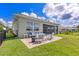Beautiful backyard with well-manicured lawn, patio seating, and lush landscaping, great for relaxation at 629 Ibiza Loop, Venice, FL 34292