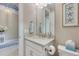 Well-lit bathroom with a modern vanity, decorative mirror, and stylish accents at 629 Ibiza Loop, Venice, FL 34292
