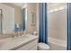 Inviting bathroom with a shower-tub combination and coastal-themed decor at 629 Ibiza Loop, Venice, FL 34292
