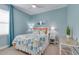 Charming bedroom with beach-themed décor, ceiling fan, and a bright, airy feel at 629 Ibiza Loop, Venice, FL 34292