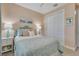Comfortable bedroom features a closet, soft lighting, and decorative pillows at 629 Ibiza Loop, Venice, FL 34292
