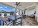 Covered patio with comfortable seating and tables overlooking the pool area at 629 Ibiza Loop, Venice, FL 34292