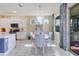 Bright dining area with a view of the modern kitchen featuring white cabinetry and accents at 629 Ibiza Loop, Venice, FL 34292