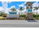 Grand entrance to the Palencia community, featuring a water feature, bell tower, and manicured landscaping at 629 Ibiza Loop, Venice, FL 34292