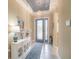 Elegant foyer with blue accents, a chandelier, and ample natural light, creating a welcoming entrance at 629 Ibiza Loop, Venice, FL 34292