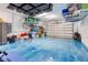 A well-organized garage featuring ample storage and a vibrant epoxy-coated floor at 629 Ibiza Loop, Venice, FL 34292