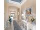 Bright hallway leading to a spacious living area, enhanced by stylish décor and neutral tones at 629 Ibiza Loop, Venice, FL 34292