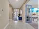 Hallway with open view to the entryway and a living room with a blue color scheme at 629 Ibiza Loop, Venice, FL 34292