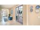 Hallway with a living room, office, and entryway visible throughout the home at 629 Ibiza Loop, Venice, FL 34292