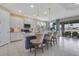 Modern kitchen with a center island, pendant lighting, and stainless steel appliances at 629 Ibiza Loop, Venice, FL 34292