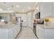 Modern kitchen with stainless steel appliances, white cabinets, and subway tile backsplash at 629 Ibiza Loop, Venice, FL 34292